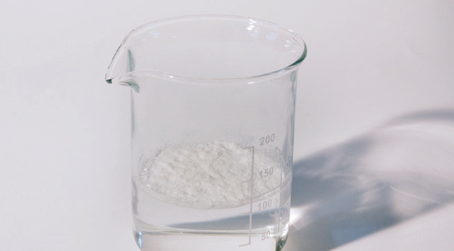 a beaker with a white substance in it