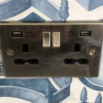a black outlet with two ports