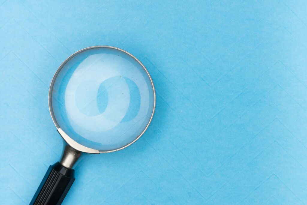 a magnifying glass on a blue surface