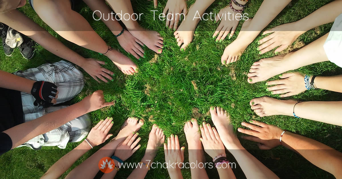 a group of people's feet in a circle in the grass