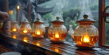 a row of glass jars with a lit candle