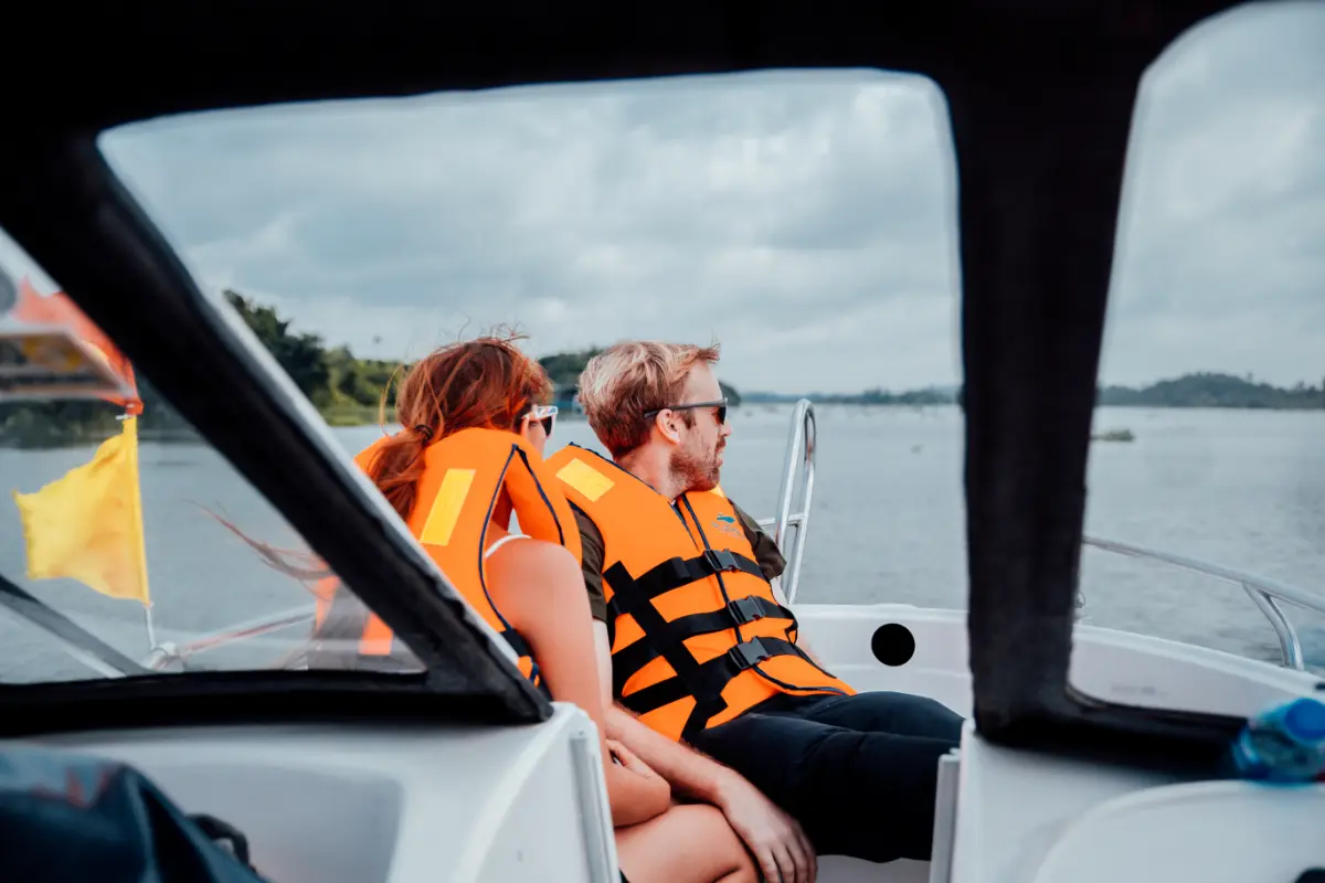 a man and woman in life jackets on a boat
