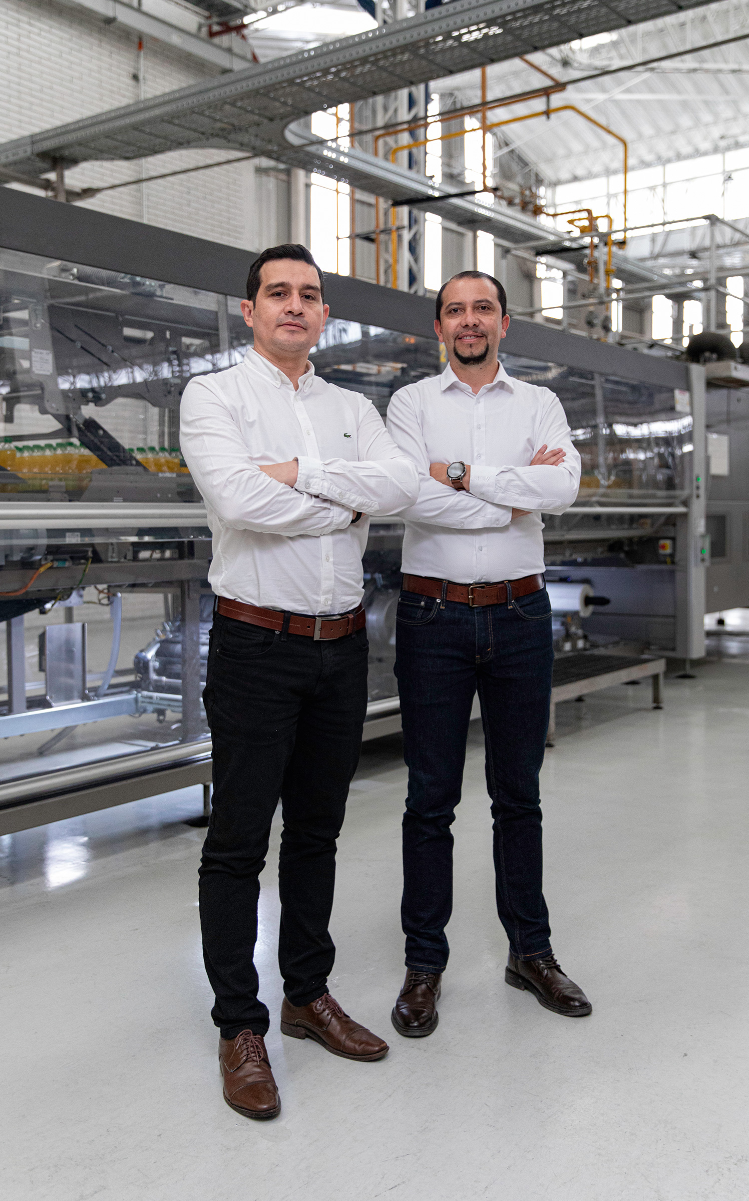 two men standing in a factory