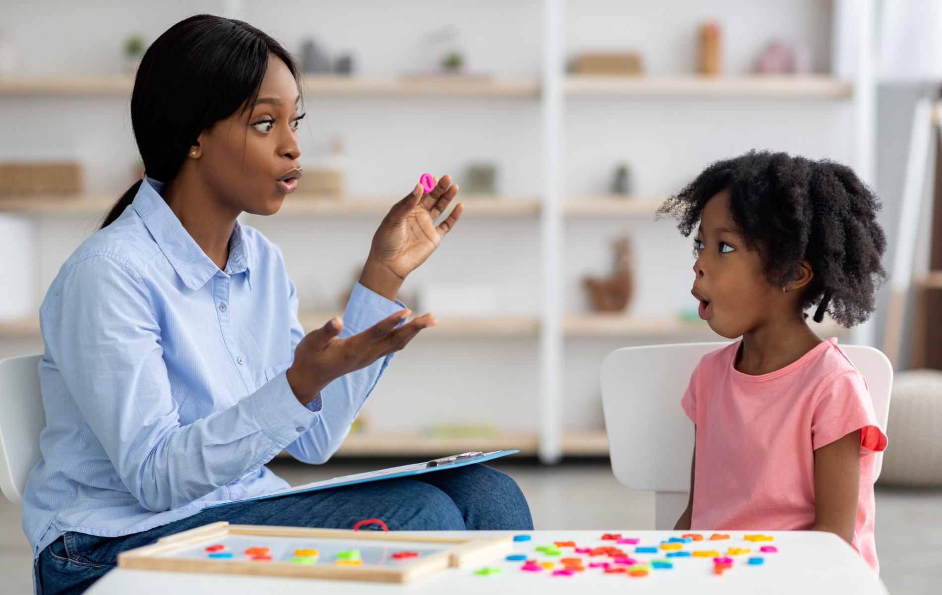 a woman and a child sitting at a table