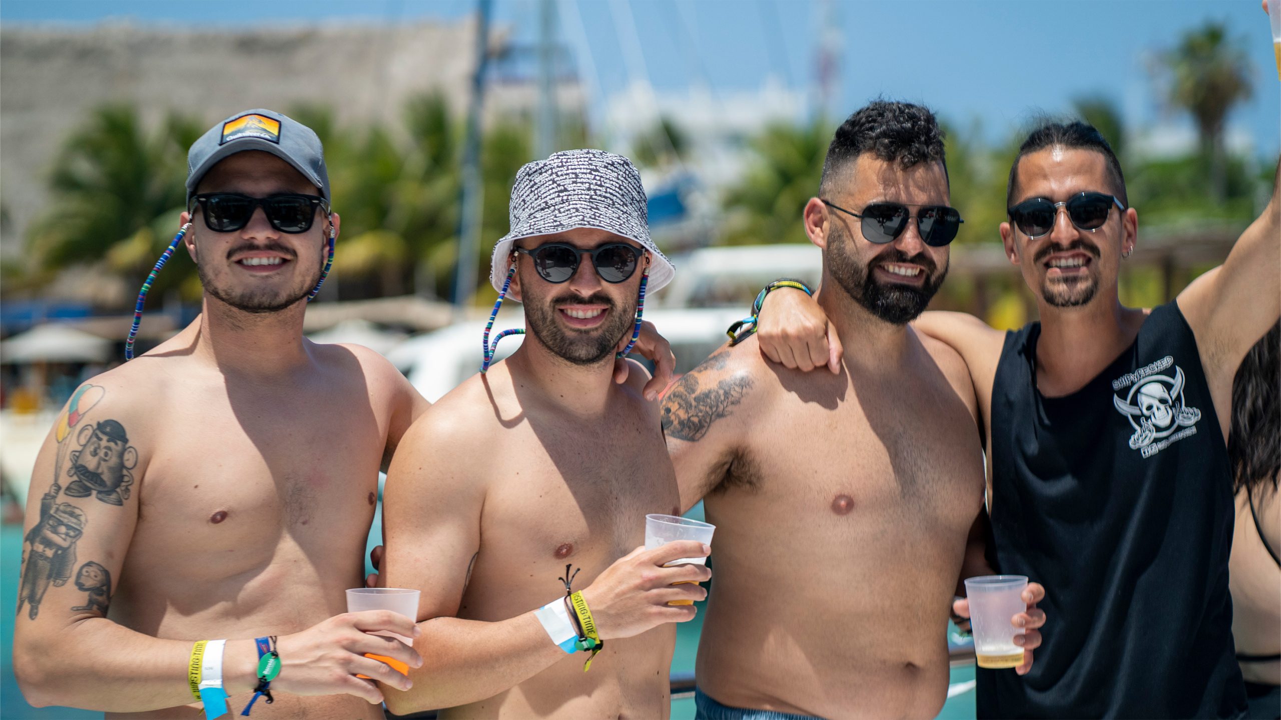 a group of men standing together with drinks