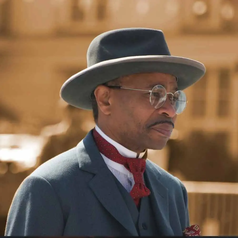 a man wearing a hat and glasses