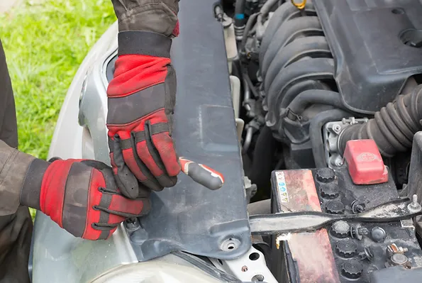 a person wearing gloves holding a tool