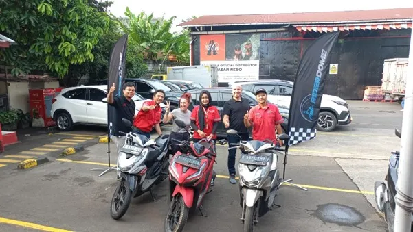 a group of people standing on motorcycles