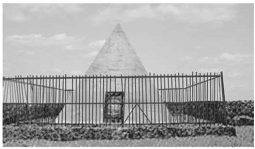 a pyramid behind a fence