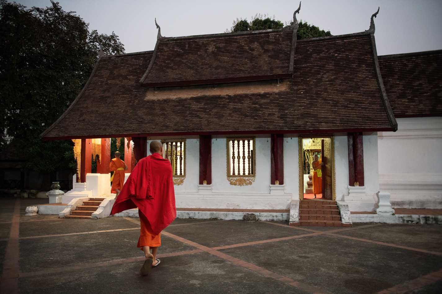 a monk walking in front of a building