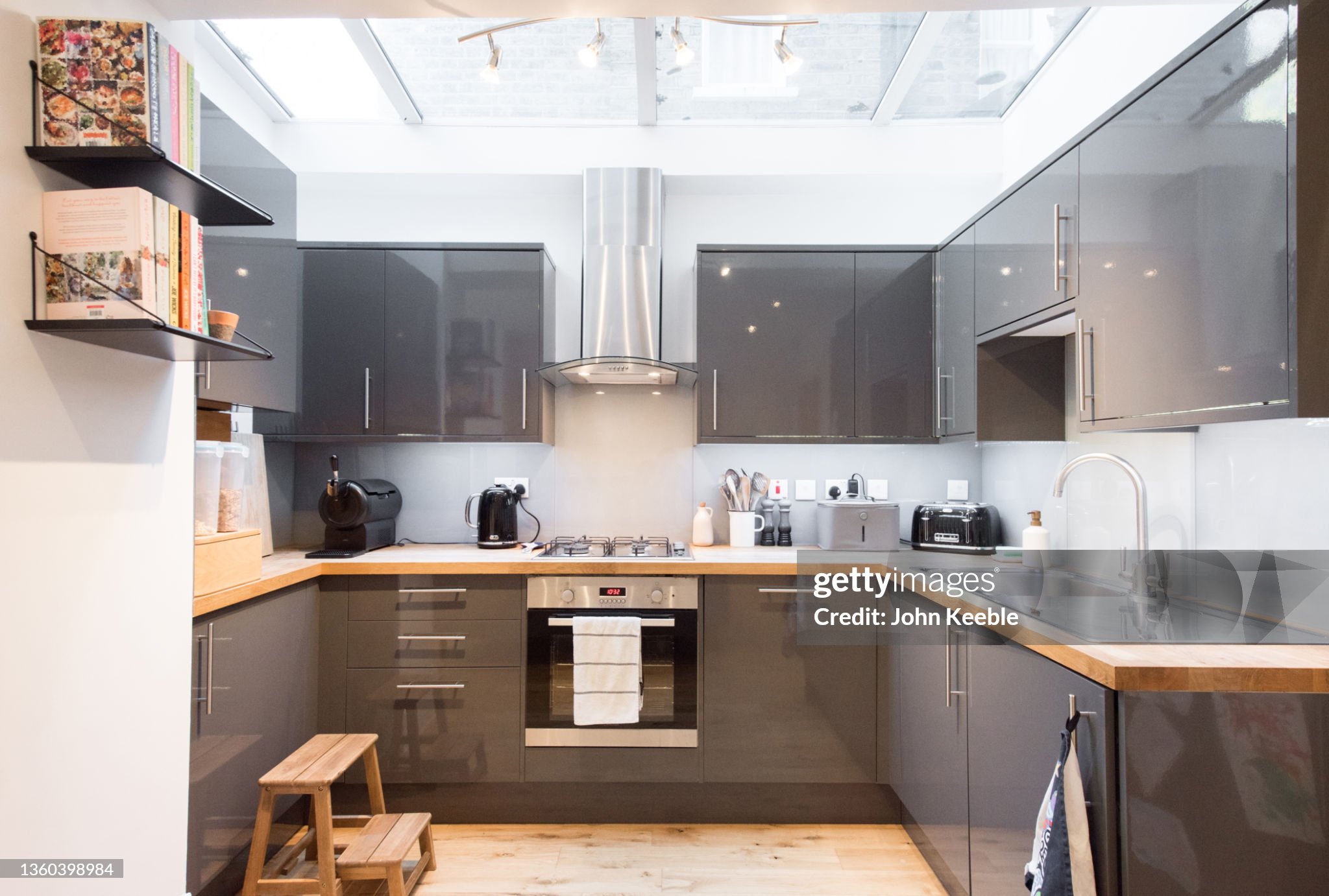 a kitchen with grey cabinets and a wooden stool