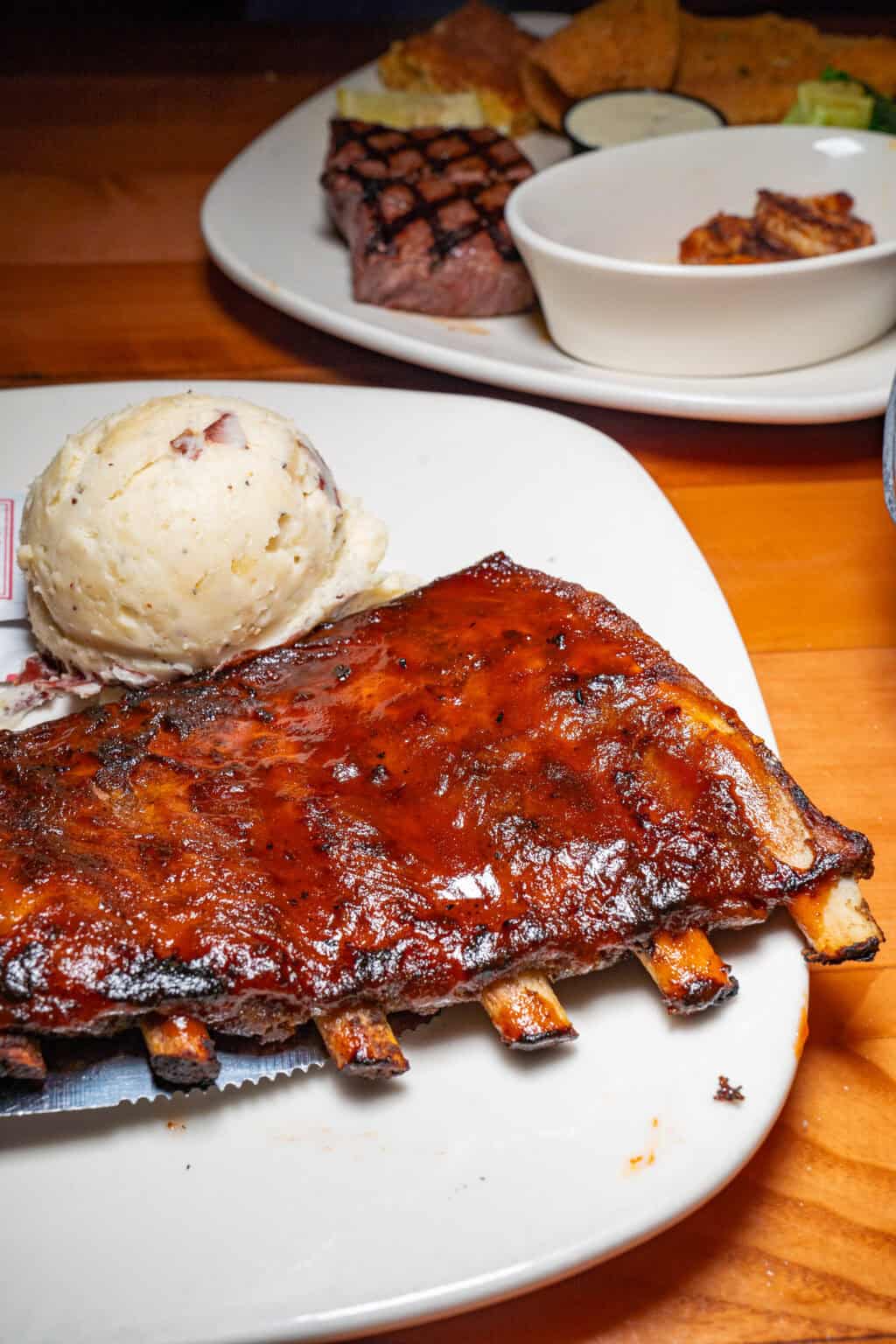 a plate of ribs and ice cream