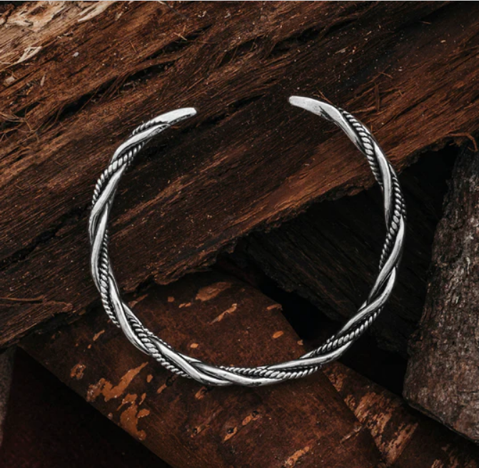a silver bracelet on wood