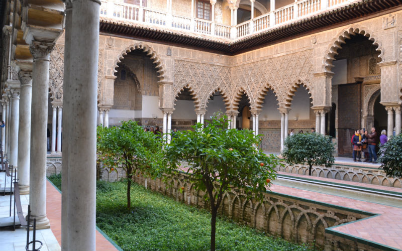 a courtyard with trees and a fountain