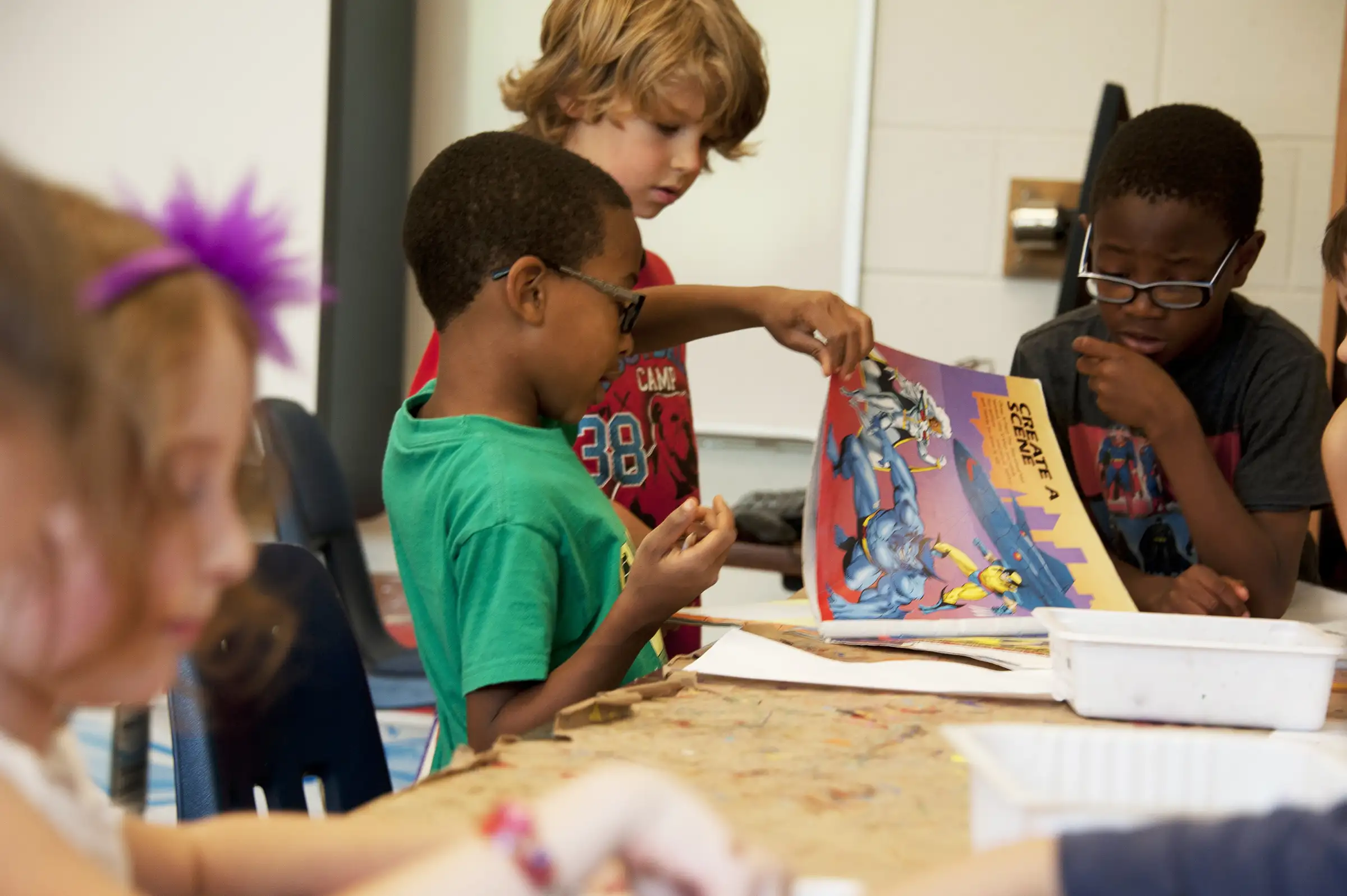 a group of kids looking at a book