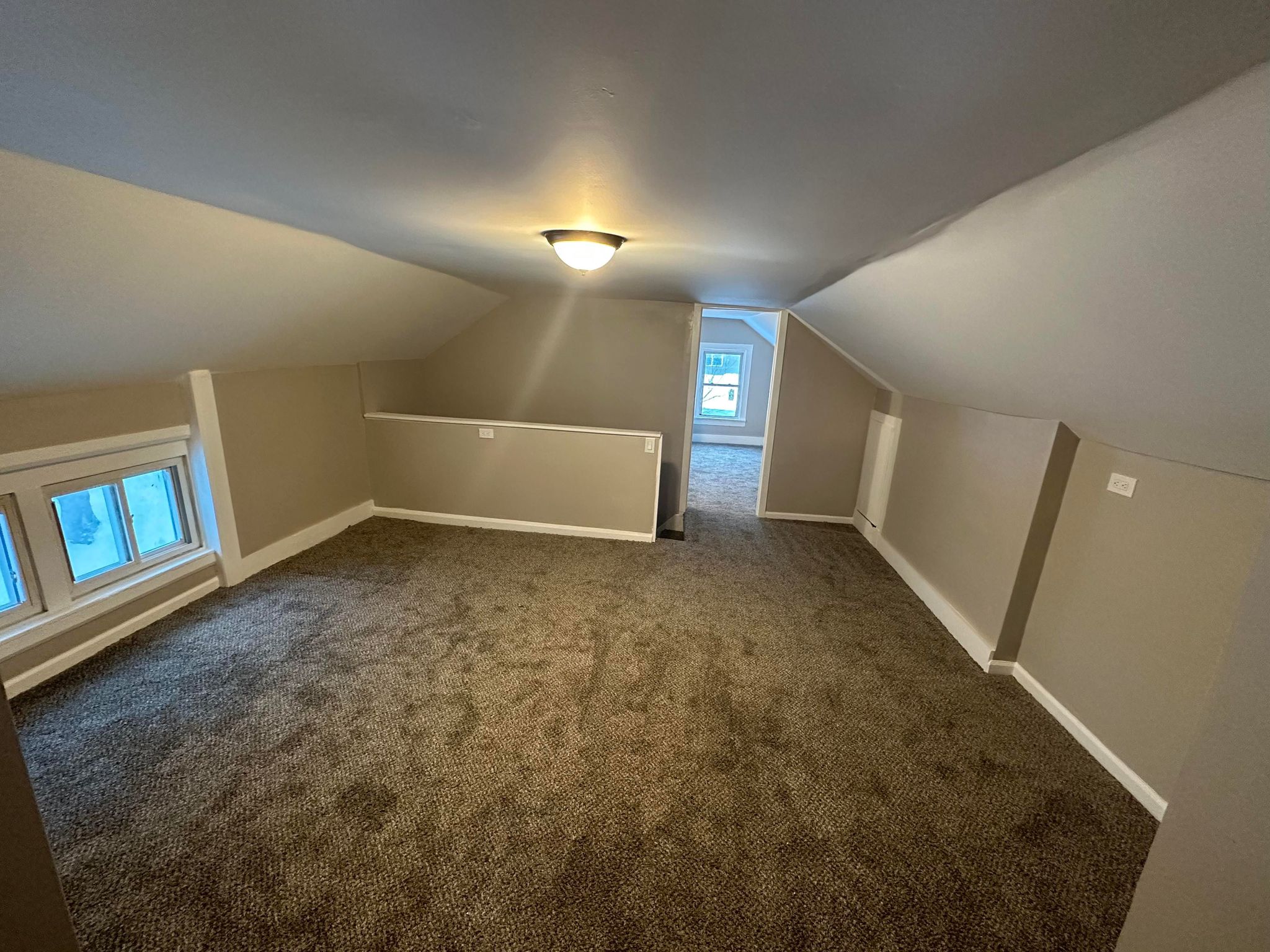 a room with a window and a light on the ceiling