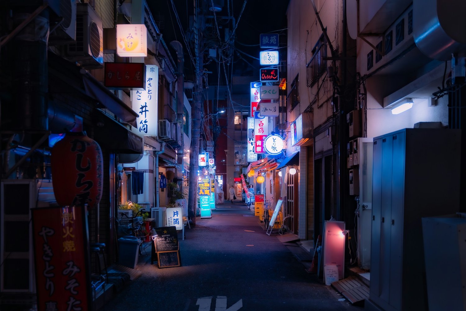 a narrow alley with signs and signs on it