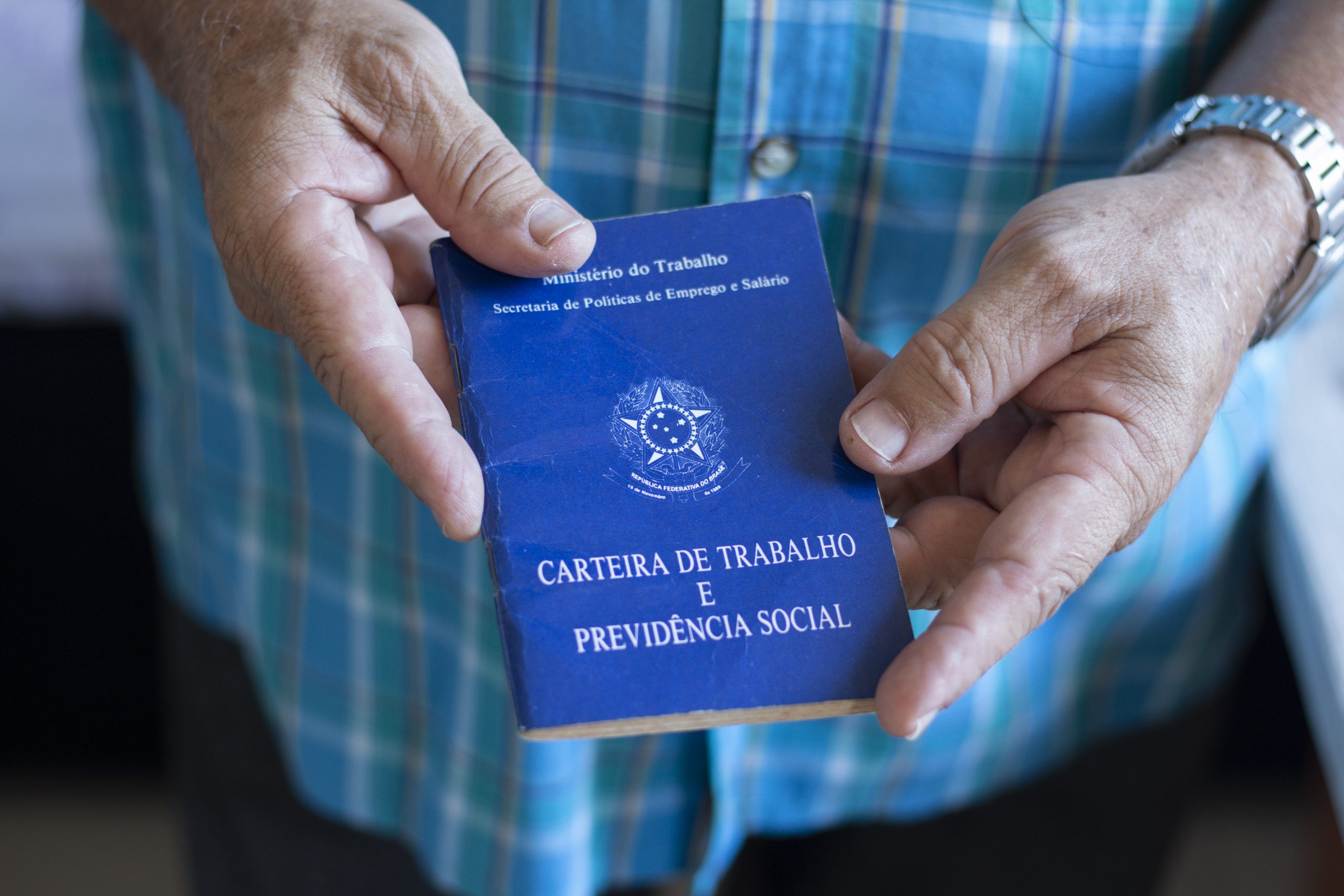 a person holding a blue book