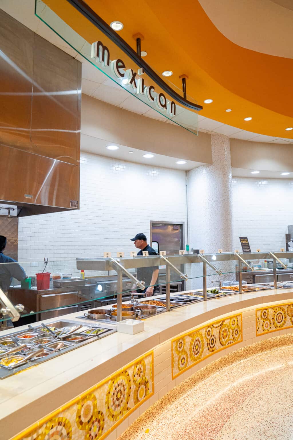 a man standing behind a counter in a restaurant