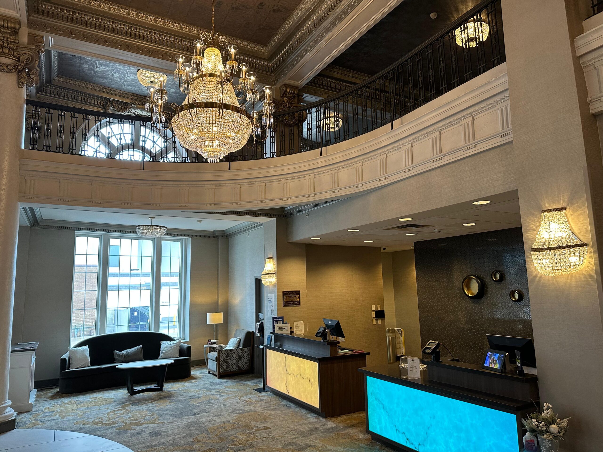 a lobby with a chandelier and a large window