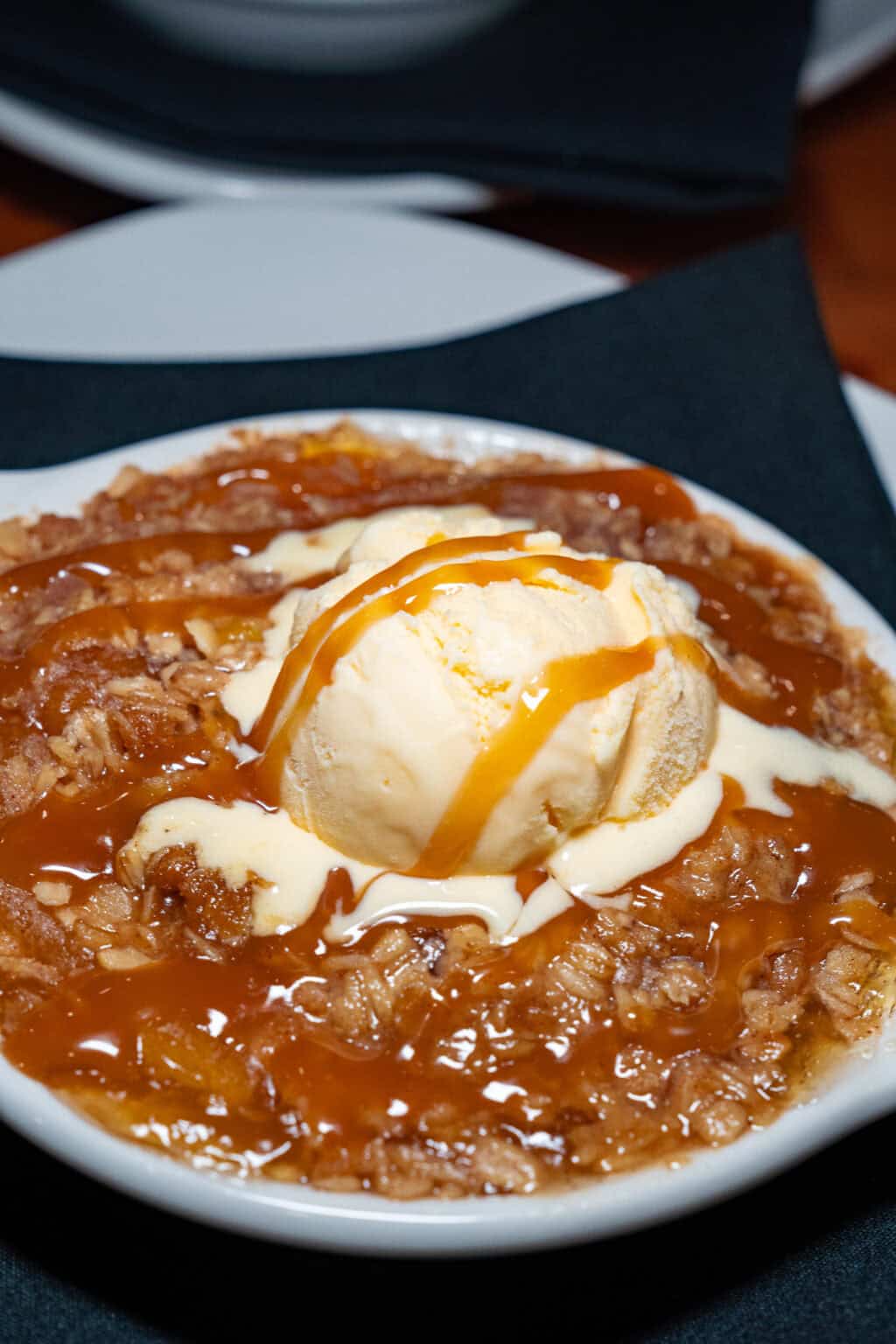 a bowl of food with ice cream and caramel sauce