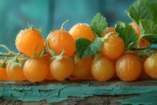 a group of round orange fruits with green leaves