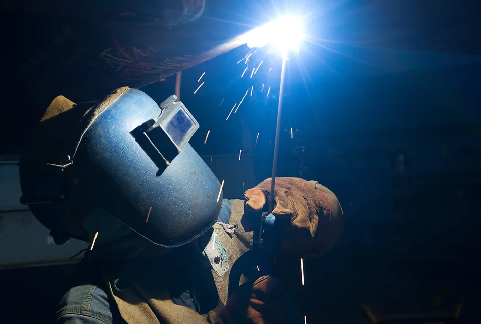 a man welding a metal pipe