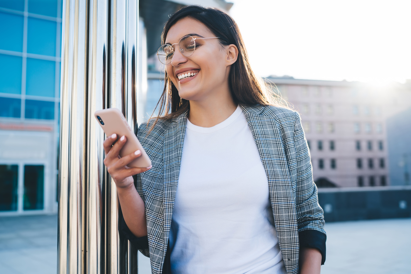 a woman smiling while holding a phone