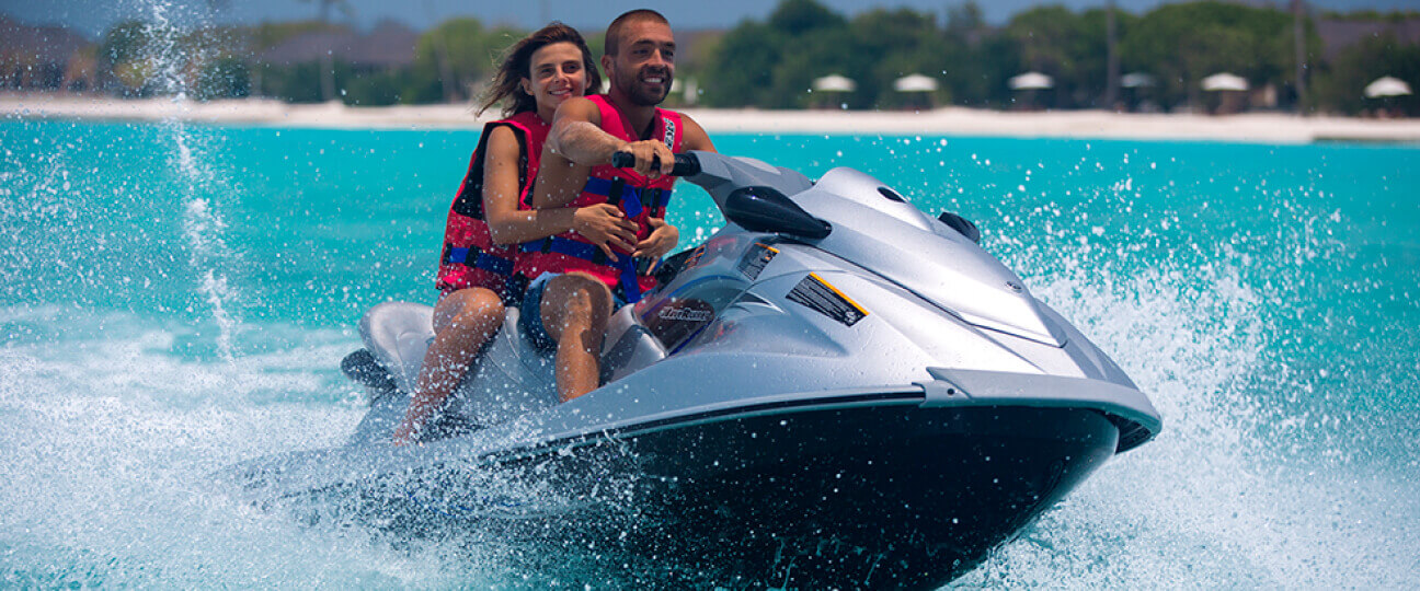 a man and woman on a jet ski
