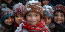 a group of children in hats and scarves with snow on their faces