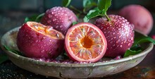 a plate of fruit with a cut in half