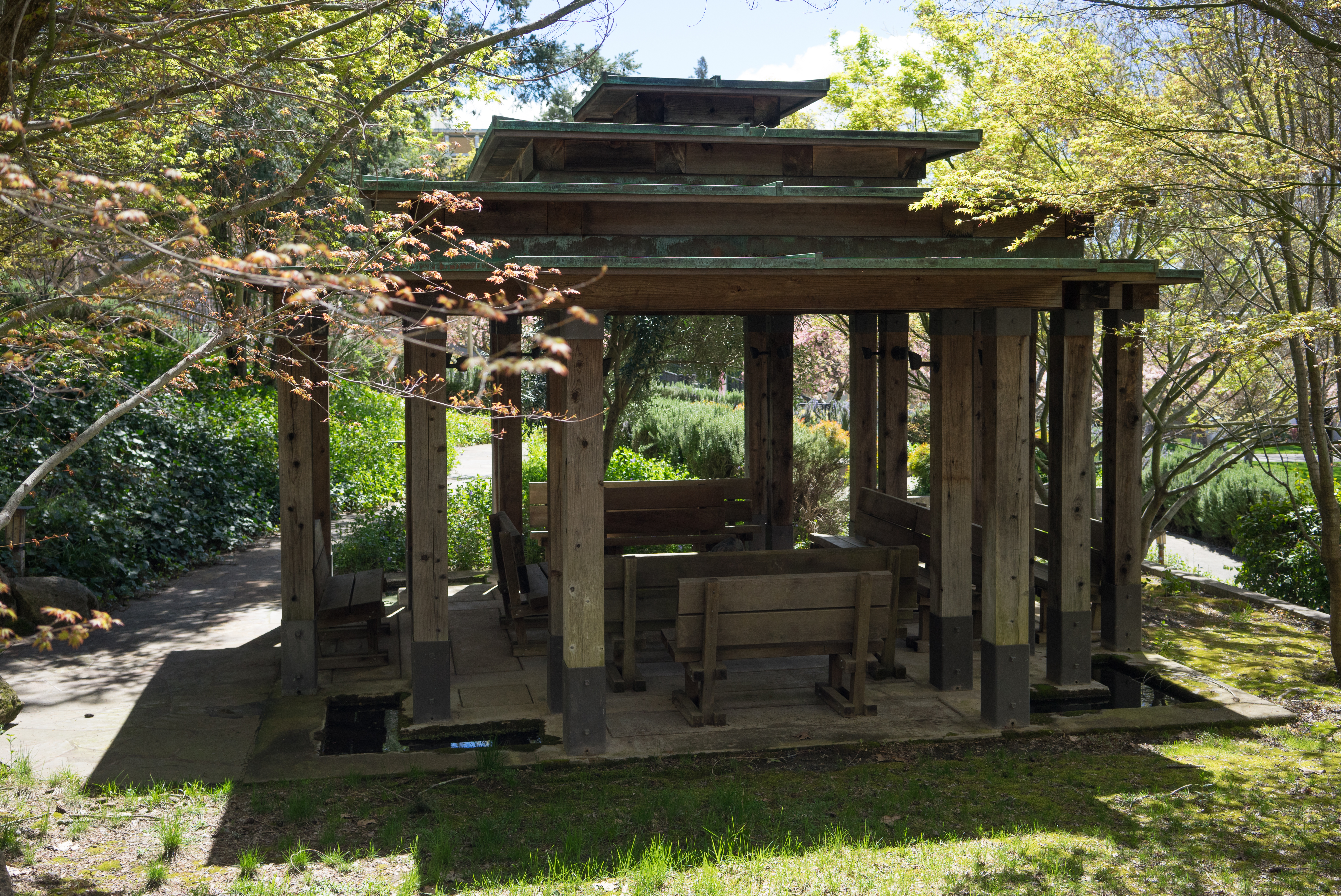 a wooden structure with benches and a gazebo