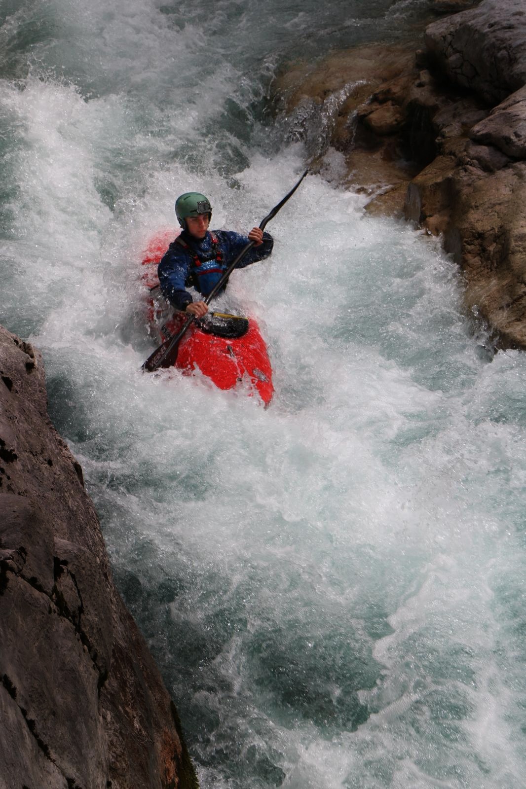 a person in a kayak in a river