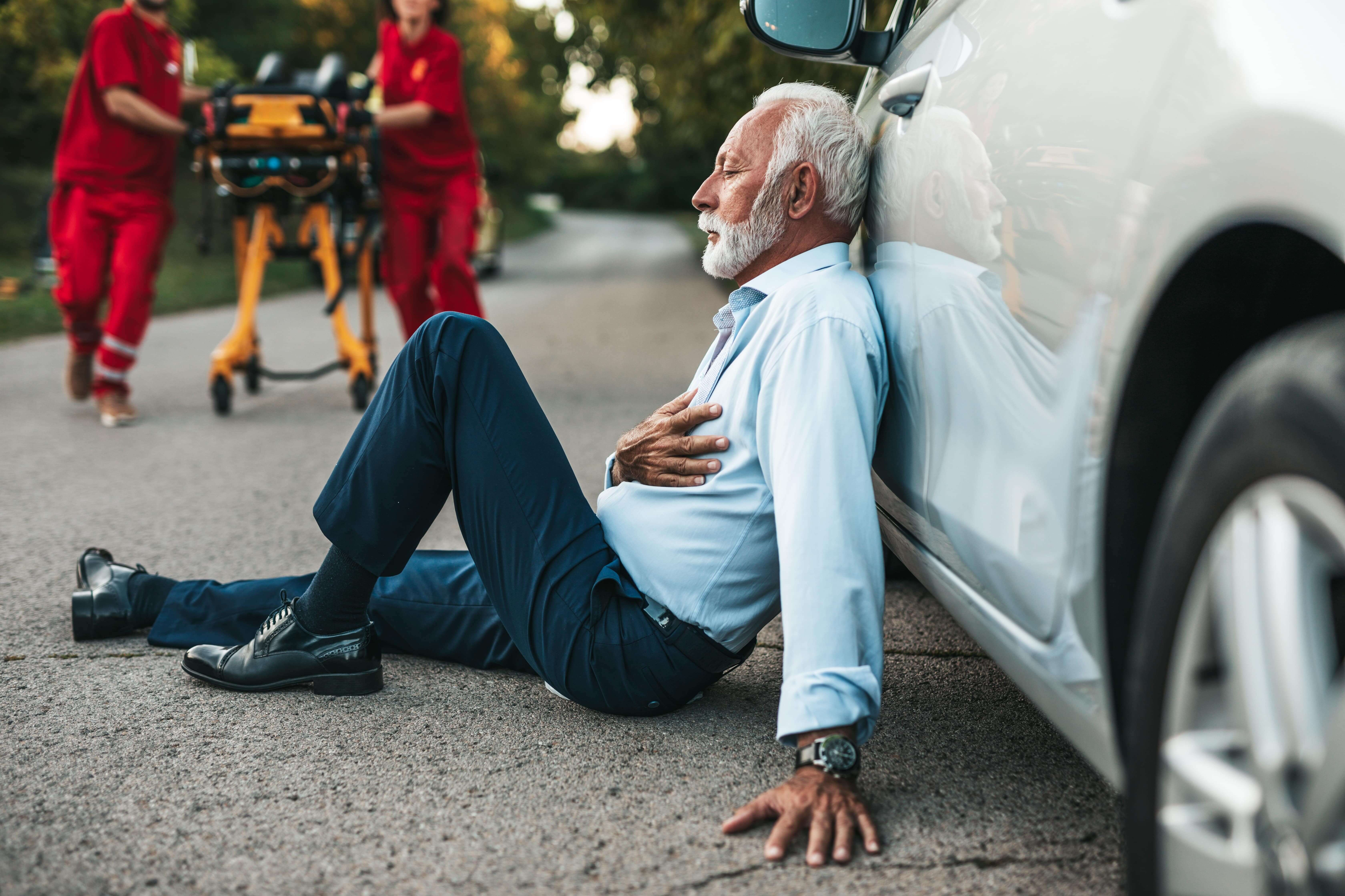 a man leaning against a car