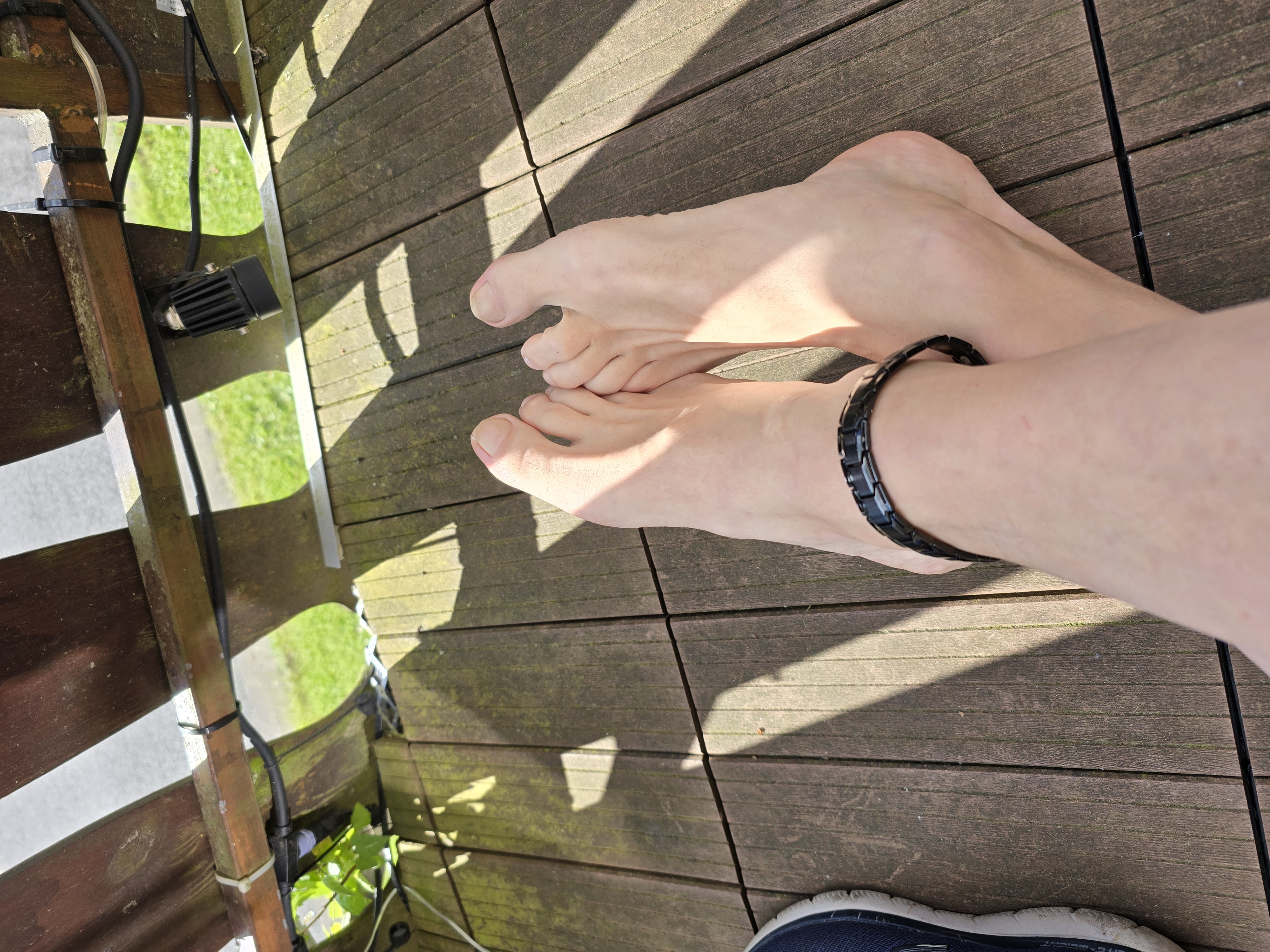 a person's feet on a deck