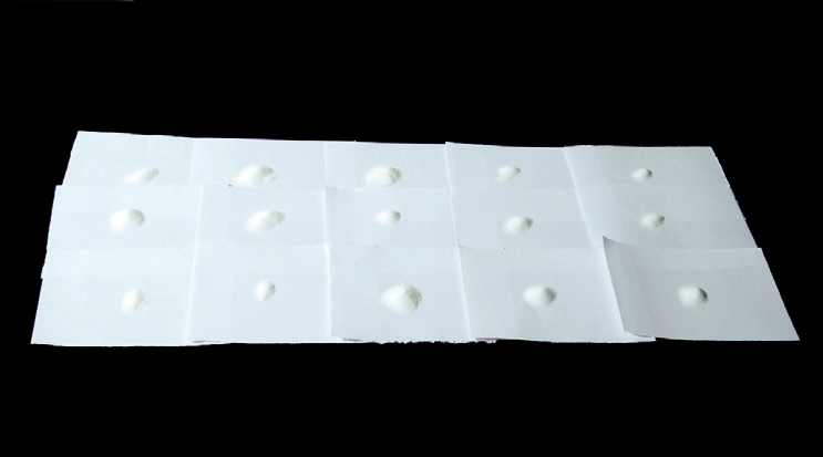 a group of white paper with white powder on it