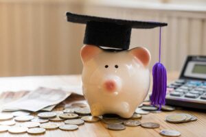 a piggy bank with a graduation cap on top of it