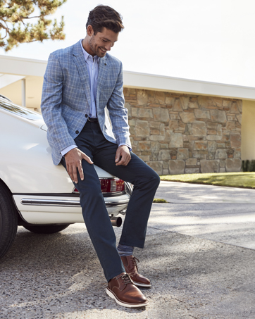 a man sitting on the back of a car