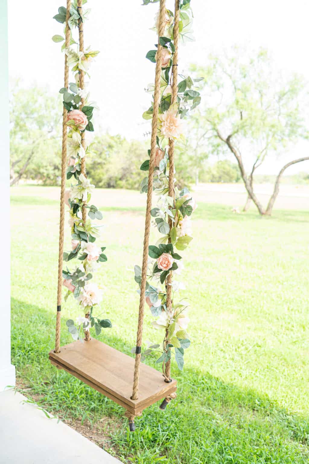 a swing with flowers on it