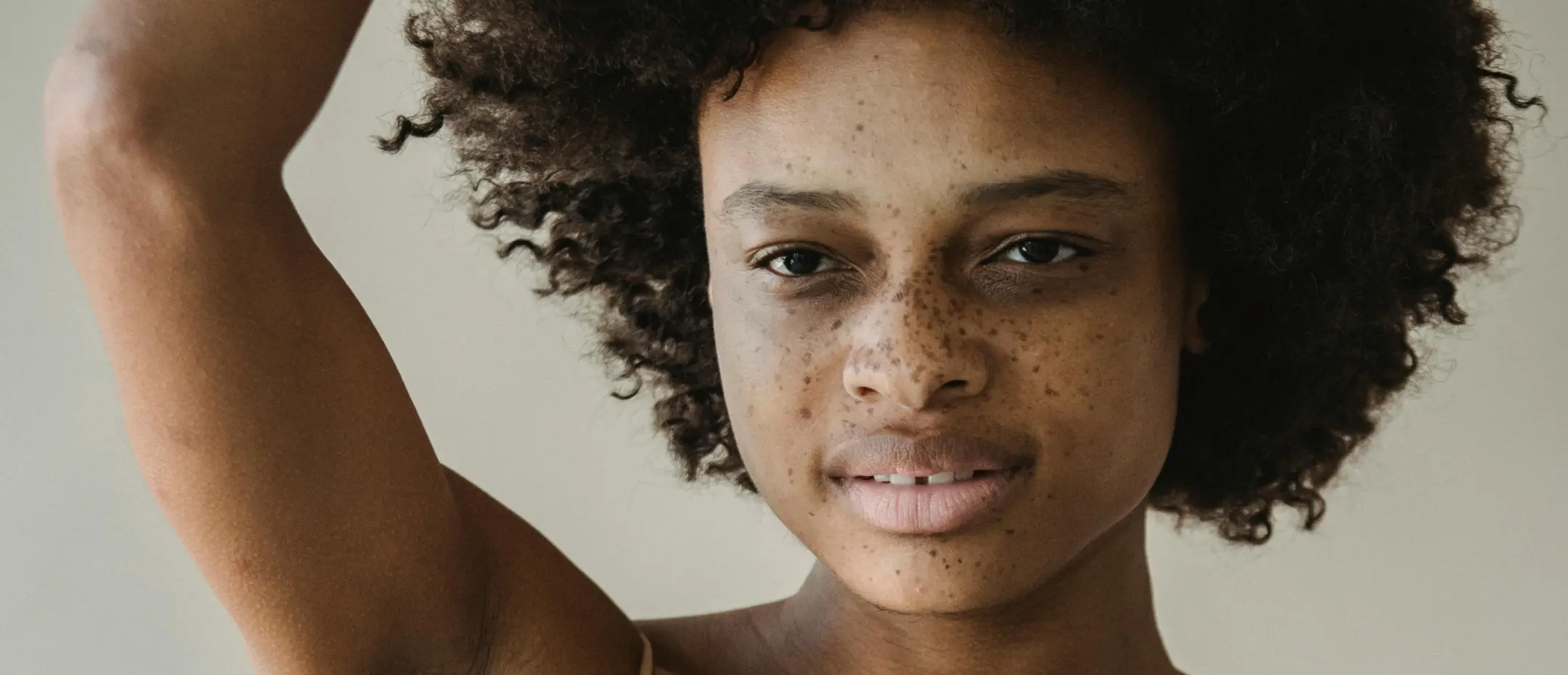 a woman with freckles and curly hair