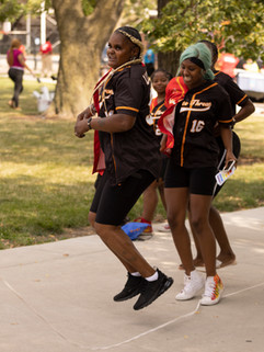 a group of women running on a sidewalk
