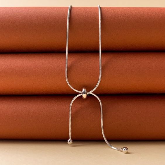 a necklace on a stack of books