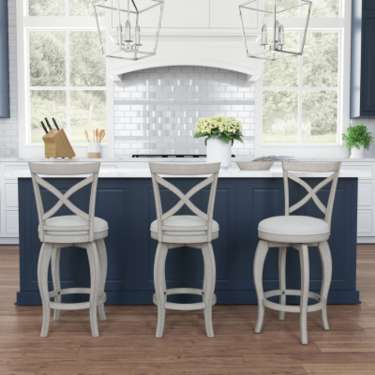 a kitchen with a blue island and white chairs