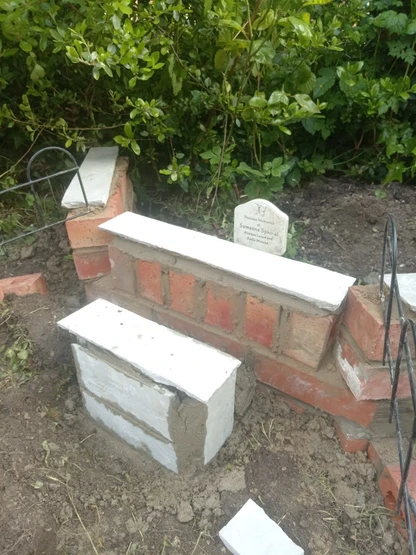 a brick wall with a white stone in the middle