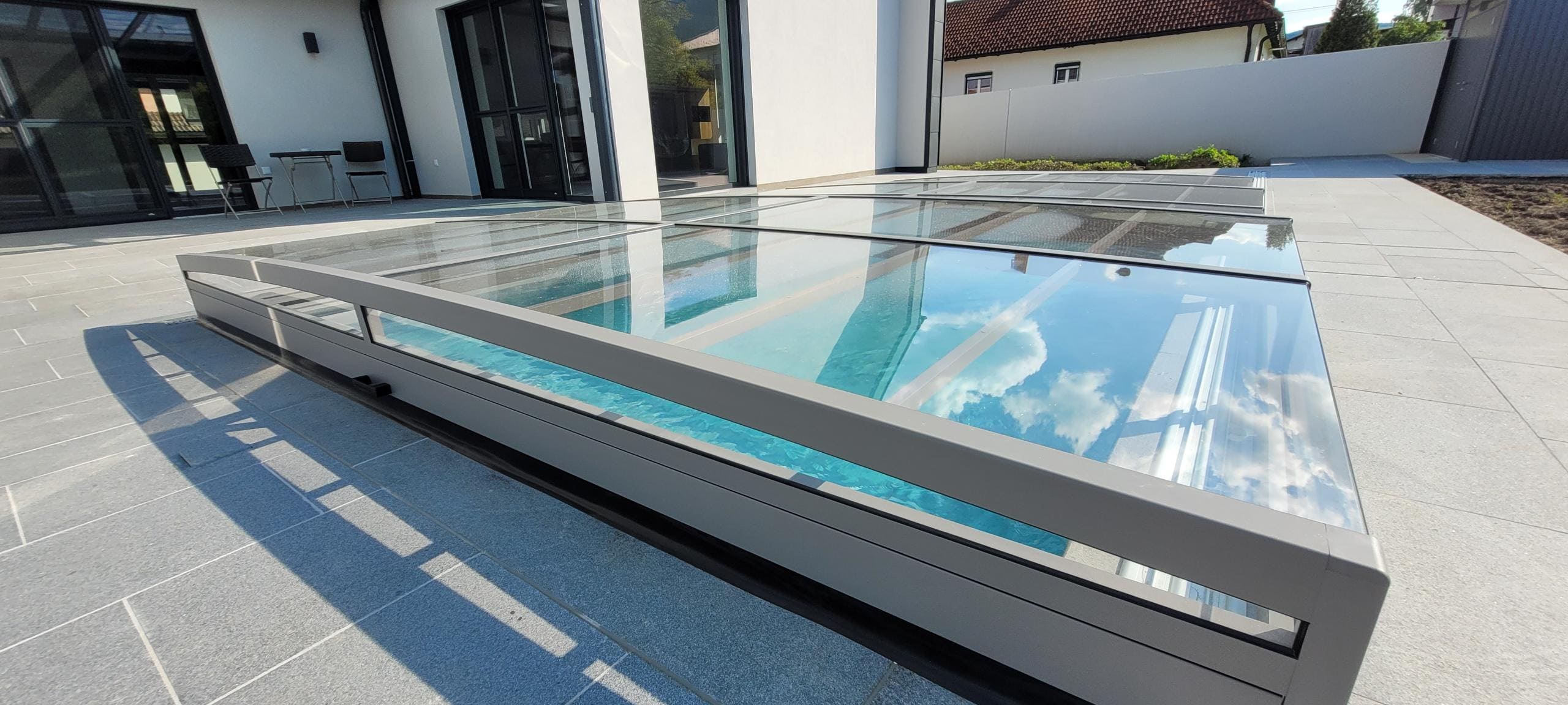 a glass roof with a pool in the middle of a building