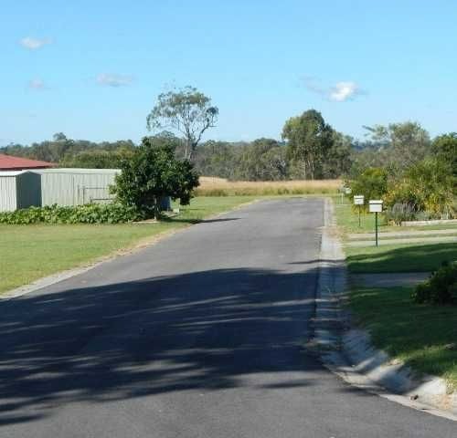 a road with grass and trees