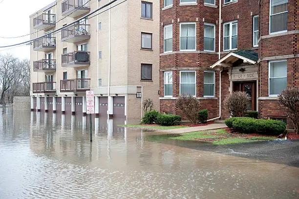 a flooded apartment building with a parking garage