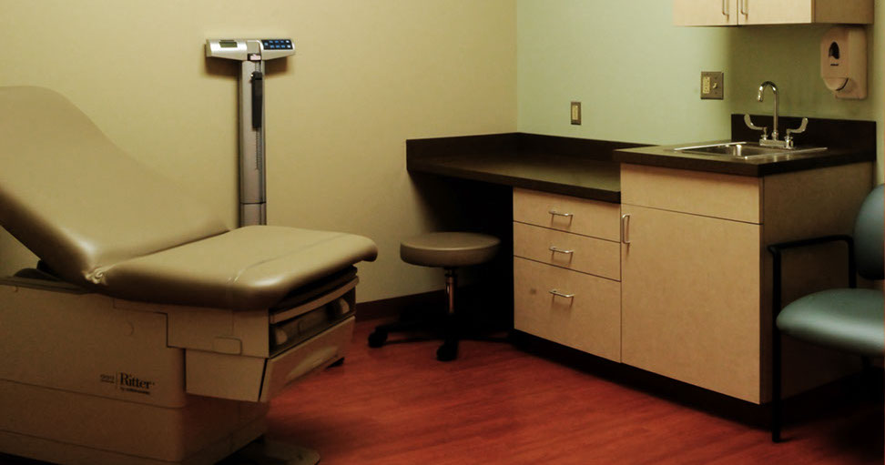 a medical room with a chair and a table