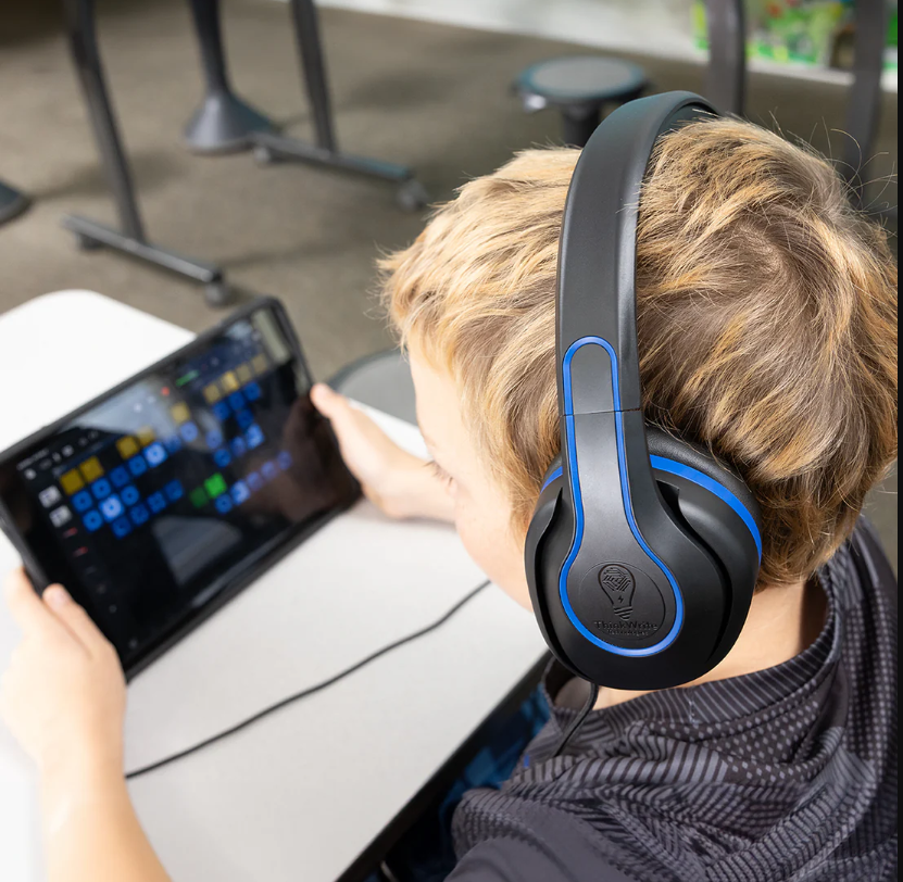 a person wearing headphones looking at a tablet