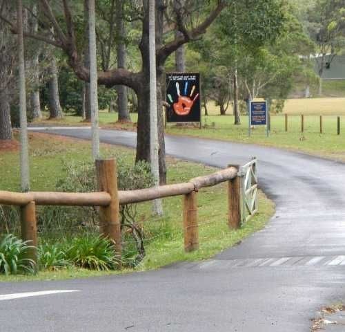 a road with a fence and a sign